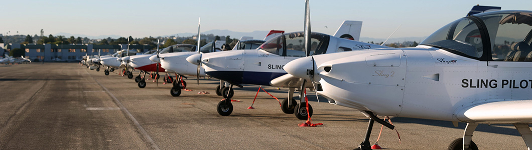 A group of students inspect a plane wing.