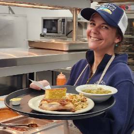 Developmental Math Director, Katie Ivester, delivers plates of food to Fork and Spoon clients