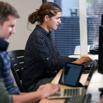 Gallatin College students writing with computers in class 